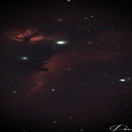 Horsehead Nebula astrophotography print showing dark horse-shaped dust cloud against glowing red hydrogen gas in Orion’s Belt – astronomy wall art.