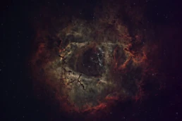 Rosette Nebula (NGC 2237) deep sky astrophotography showing the dark central cavity surrounded by glowing hydrogen gas in the Monoceros constellation.