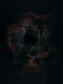 Rosette Nebula (NGC 2237) deep sky astrophotography showing the dark central cavity surrounded by glowing hydrogen gas in the Monoceros constellation.