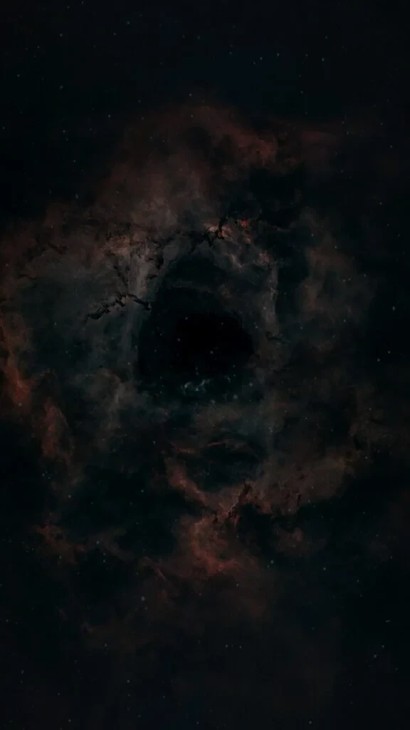 Rosette Nebula (NGC 2237) deep sky astrophotography showing the dark central cavity surrounded by glowing hydrogen gas in the Monoceros constellation.